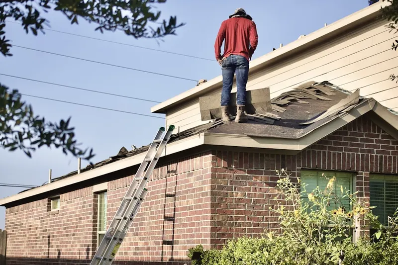 Professional roofer working on a residential roof in Mays